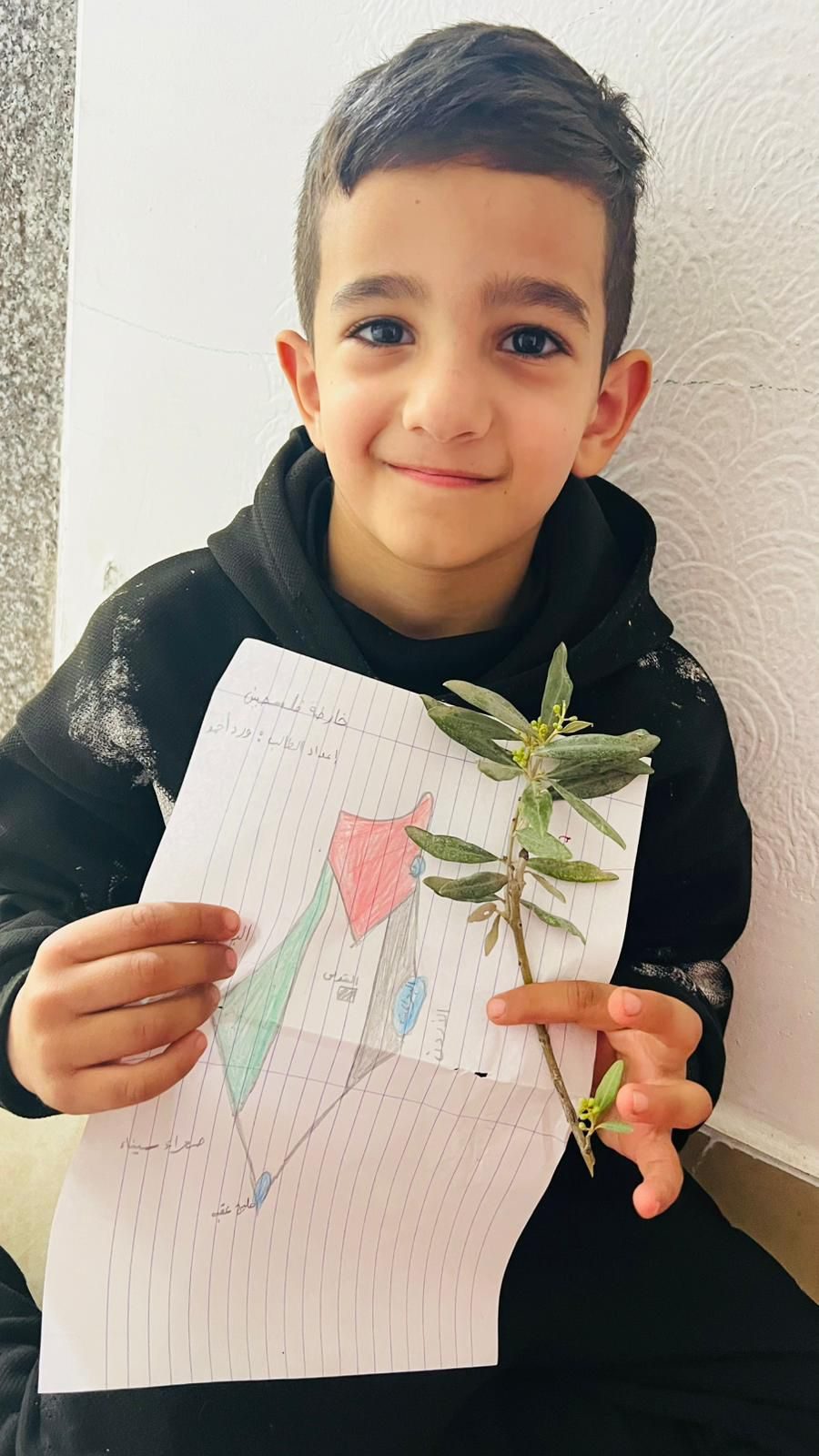 Child holding artwork