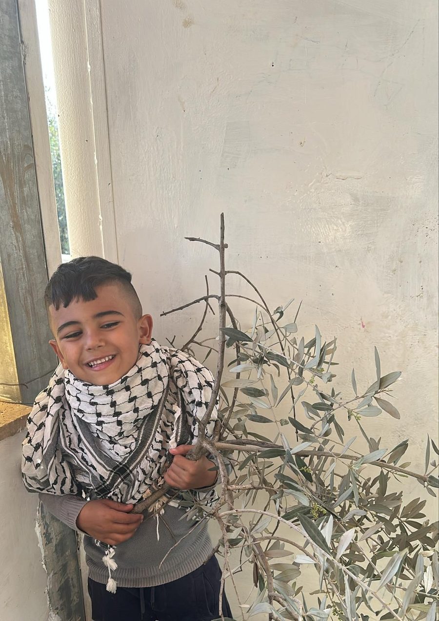 Child holding a plant drawing
